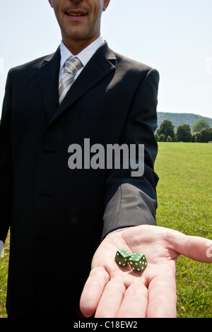Businessman holding dice Stock Photo