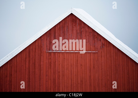 Red barn covered with snow Stock Photo