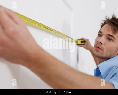 Man is concentrating while measuring