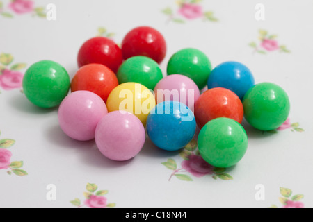 gobstopper balls sweets and candy on a paper background photographed in a studio
