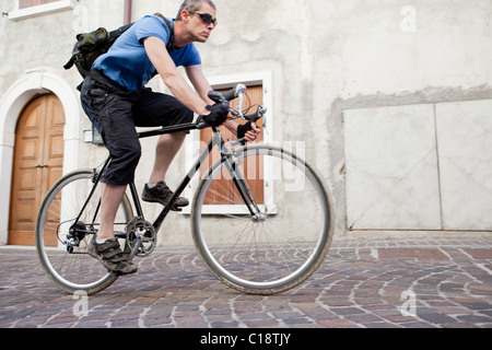 Man on black vintage road bike Stock Photo