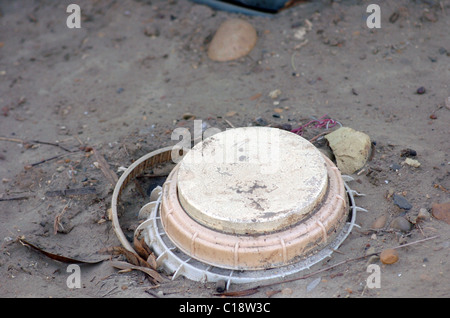 A land mine is a target (person or vehicle) triggered explosive weapon Stock Photo