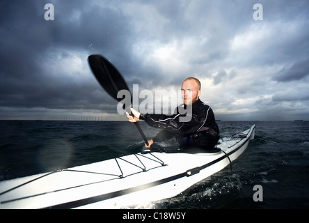 blonde male Man in a wetsuit surfing a wave in the ocean Stock Photo ...