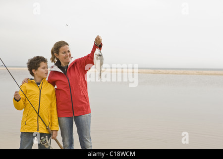 Mother and son looking proudly at fish Stock Photo