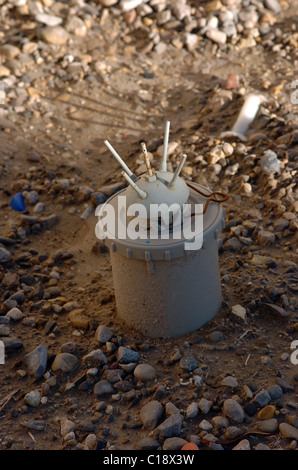 A land mine is a target (person or vehicle) triggered explosive weapon Stock Photo