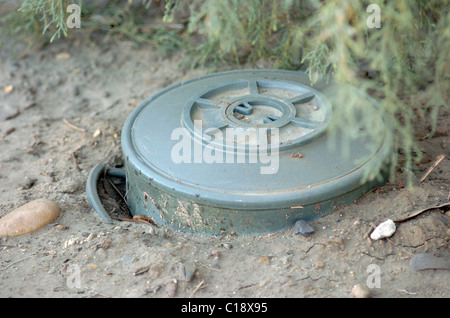 A land mine is a target (person or vehicle) triggered explosive weapon Stock Photo