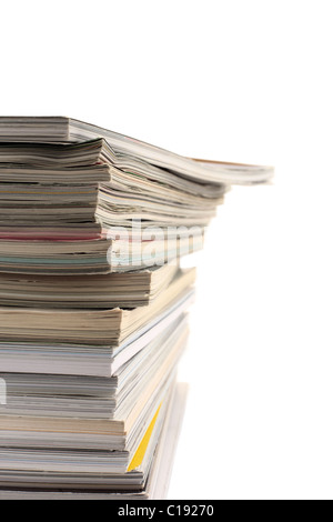 A pile of used magazines with empty copy space to the right. Stock Photo