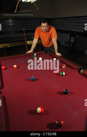 Snooker player taking a long shot across the table  Stock Photo