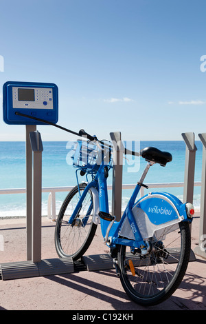 Velobleu roadside rental machine with a bicycle attached on the Promenade des Anglais, Nice, Alpes-Maritime, France Stock Photo