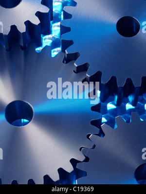 Cog wheels on blue surface Stock Photo