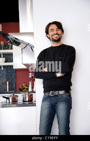 Man standing in his new kitchen Stock Photo