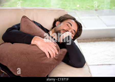 Man sleeping on a sofa Stock Photo