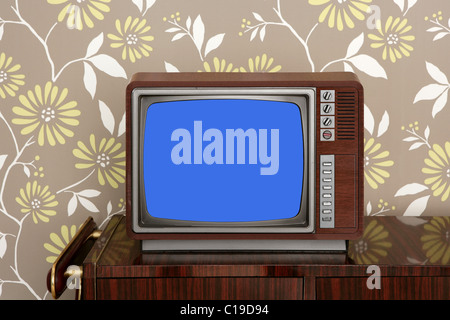 retro wooden tv on wooden vintage 60s furniture floral wallpaper Stock Photo