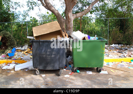 dirty trash containers messy dirt everywhere on street Stock Photo