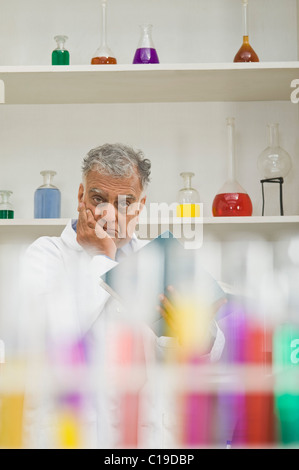 Scientist thinking in a laboratory Stock Photo