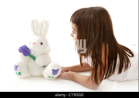 beautiful little latin girl playing with white toy Stock Photo
