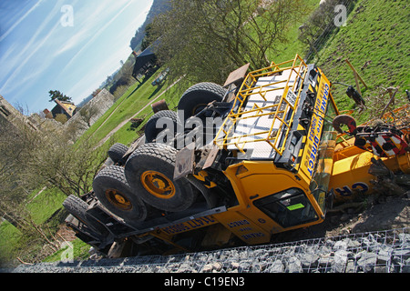 An overturned lorry mounted crane lies in a field at Stokesay,  Shropshire, England, UK Stock Photo
