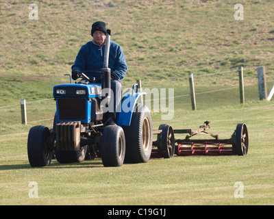 Old man on a ride on mower, UK Stock Photo