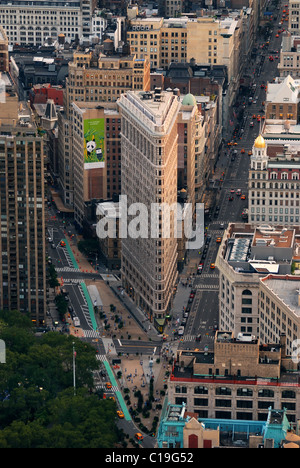 Flat Iron building, considered to be one of the first skyscrapers ever built, with New York City Manhattan street aerial view. Stock Photo