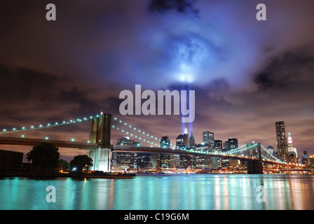 New York City Manhattan panorama view with Brooklyn Bridge at night with office building skyscrapers skyline illuminated Stock Photo