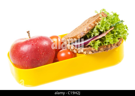 Yellow plastic lunch box with sandwich and apple Stock Photo