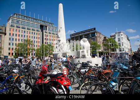 Bicycles in Dam Square.  National Monument, Verwelius and Grand Hotel Krasnapolsky buildings. Amsterdam. Netherlands. Stock Photo