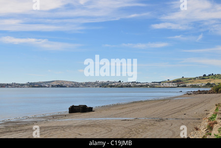 Blue sky beach view across Ancud Bay towards the town of Ancud, viewed from the road to Quetalmahue, Chiloe Island, Chile Stock Photo