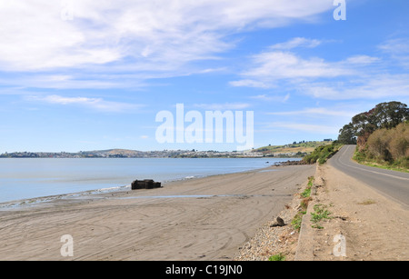 Blue sky beach view, from the W20 road to Quetalmahue, looking across Ancud Bay towards the town of Ancud, Chiloe Island, Chile Stock Photo