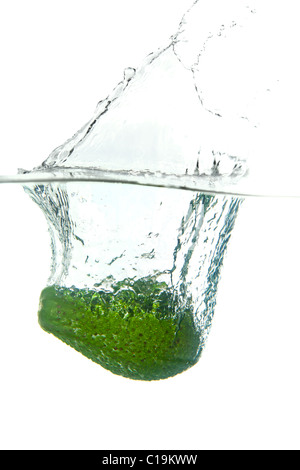 Green avocado in water splash isolated on white background Stock Photo