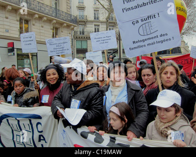 Paris, France, French NGO,  Immigrants Families Women Marching in Demonstration, Protesting Against Forced Housing Expulsions, Crowd with French Protest Posters, children at protests, family protest, diverse  multiracial group Stock Photo