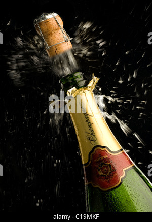 Champagne cork popping from bottle Stock Photo