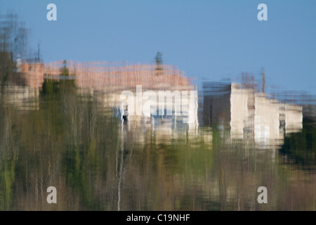 reflections of houses in the water of the Soumensac reservoir Stock Photo