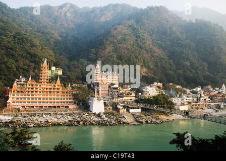 Temples at the riverbank, Swarg Niwas Temple, Lakshman Jhula, Ganges River, Rishikesh, Uttarakhand, India Stock Photo