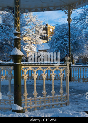 Hexham Abbey framed by a snow-covered bandstand in the Sele Park, Hexham, Northumberland, England Stock Photo