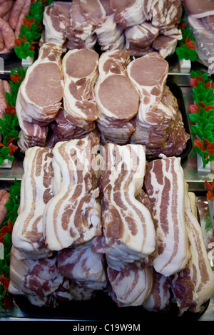 Bacon on display in a butchers shop Stock Photo