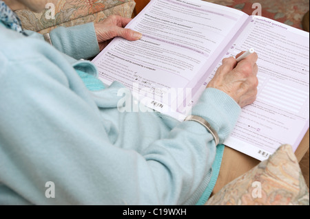 elderly woman filling in census form 2011 UK Stock Photo