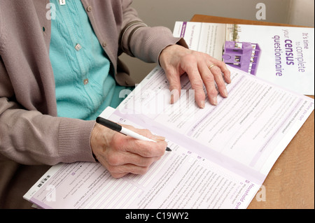 elderly woman filling in census form 2011 UK Stock Photo