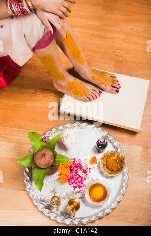 Low section view of a bride in traditional Bengali dress with pooja thali Stock Photo