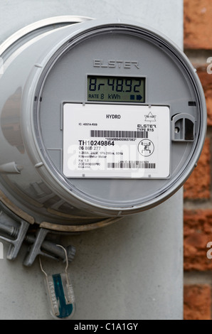 Hyrdro electrical Smart Meter retrofit outside a brick house Stock Photo