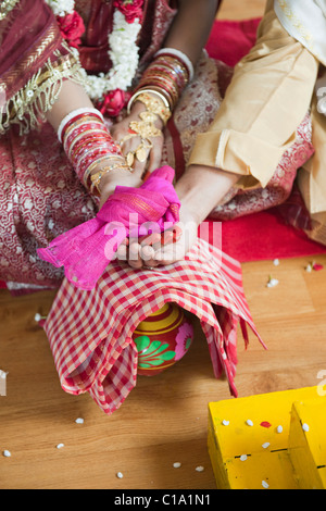 Mid section view of a couple performing Sampradan ceremony in Bengali wedding Stock Photo