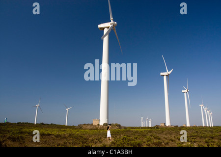 View of a young girl watching a windmill. Stock Photo