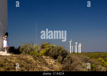 View of a young girl watching a windmill. Stock Photo