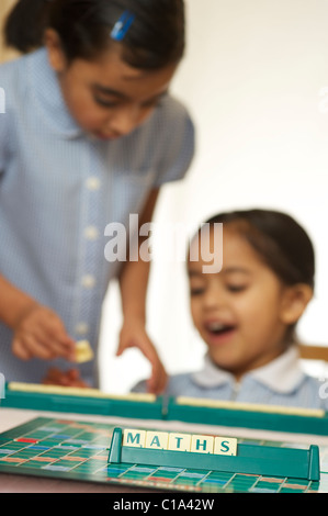 Kids playing scrabble game Stock Photo