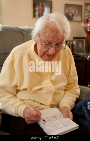 An elderly woman manages to take care of herself, living alone in her own home in Adams, Massachusetts.  MODEL RELEASE Stock Photo