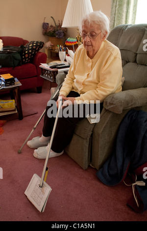 An elderly woman manages to take care of herself, living alone in her own home in Adams, Massachusetts.  MODEL RELEASE Stock Photo