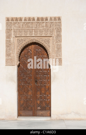Textured carvings surround carved doorway, Arabic themes, in the Alhambra. Granada, Spain Stock Photo