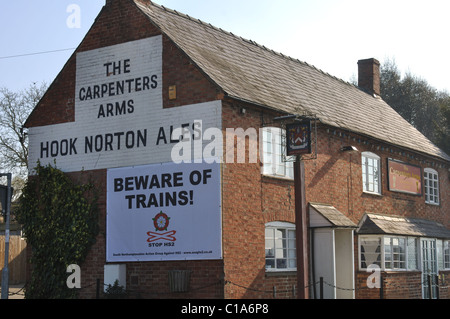Poster against HS2 rail link on The Carpenters Arms pub, Lower Boddington, Northamptonshire, England, UK Stock Photo