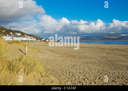 Few people walking walkers on the beach seaside sands sandy sand at Aberdovey Aberdyfi coast in winter Gwynedd Wales UK United Kingdom GB Britain Stock Photo