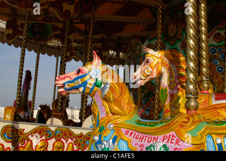 Brightly coloured fairground horse on traditional roundabout. Brighton Pier. East Sussex. England Stock Photo