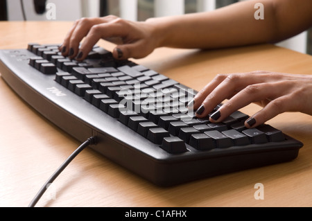 Typing on a computer keyboard Stock Photo